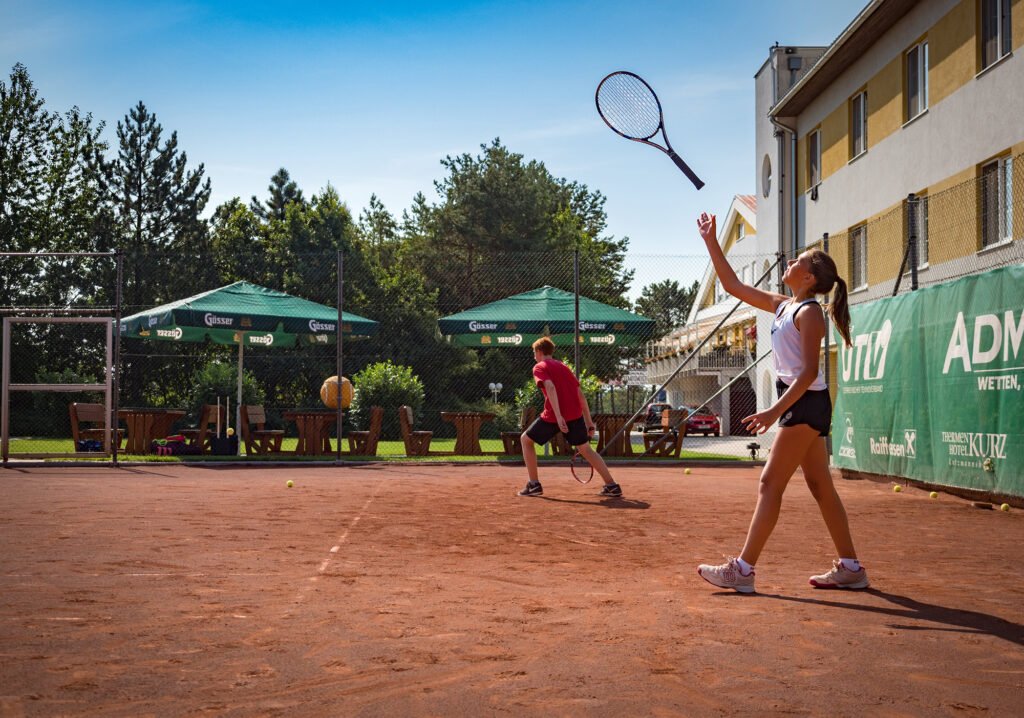 Young Girl Throwing Tennis Racket in the Air